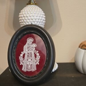 Black Oval Frame with Red and White Lace Art